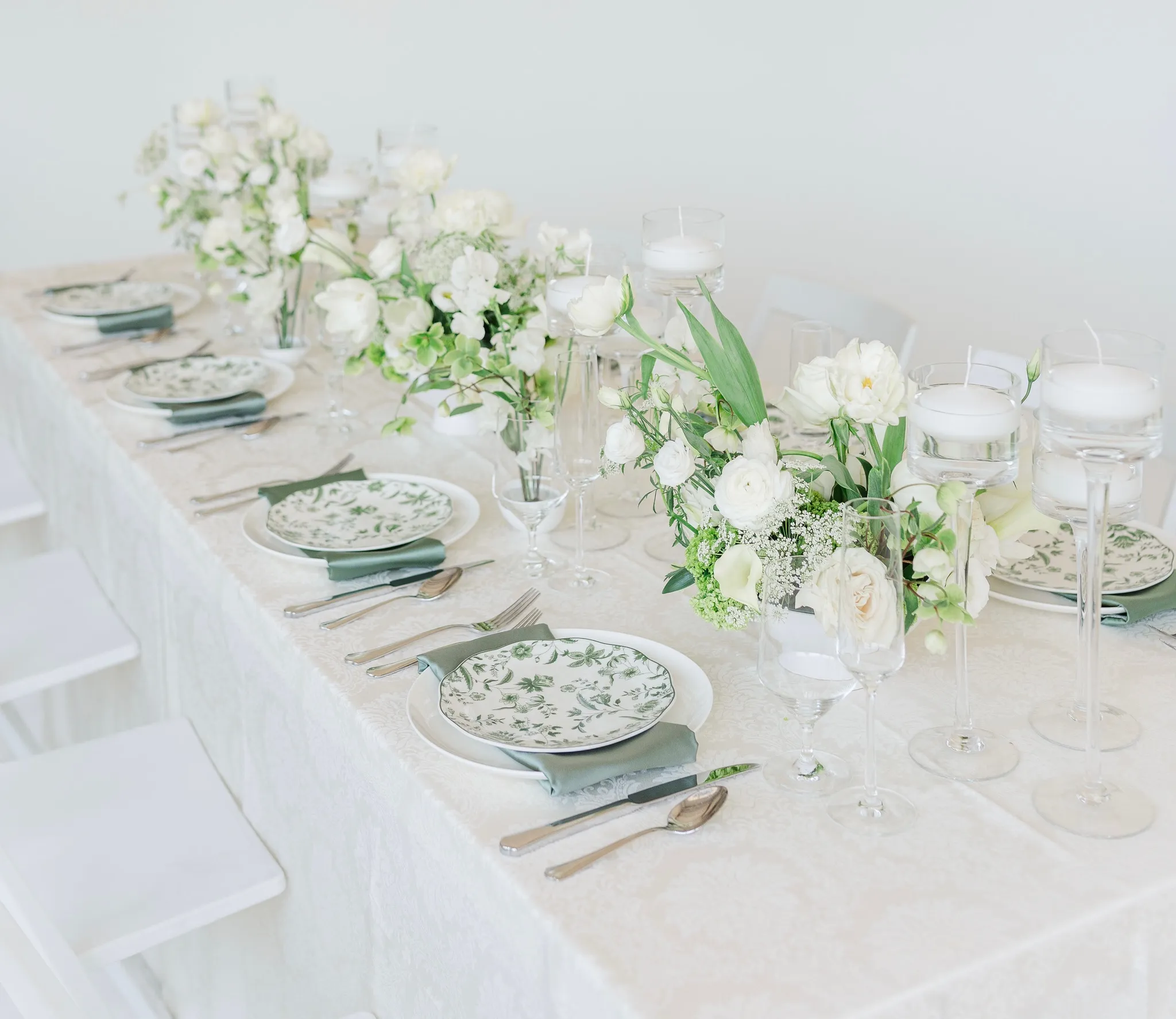 Chartreuse and white compote arrangement with floating candles