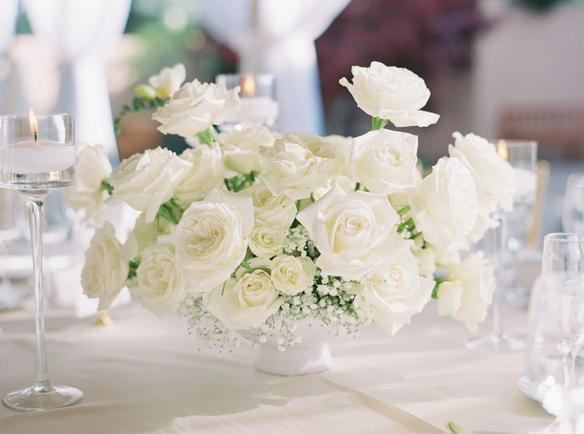 White rose and baby's breath centerpiece with candles