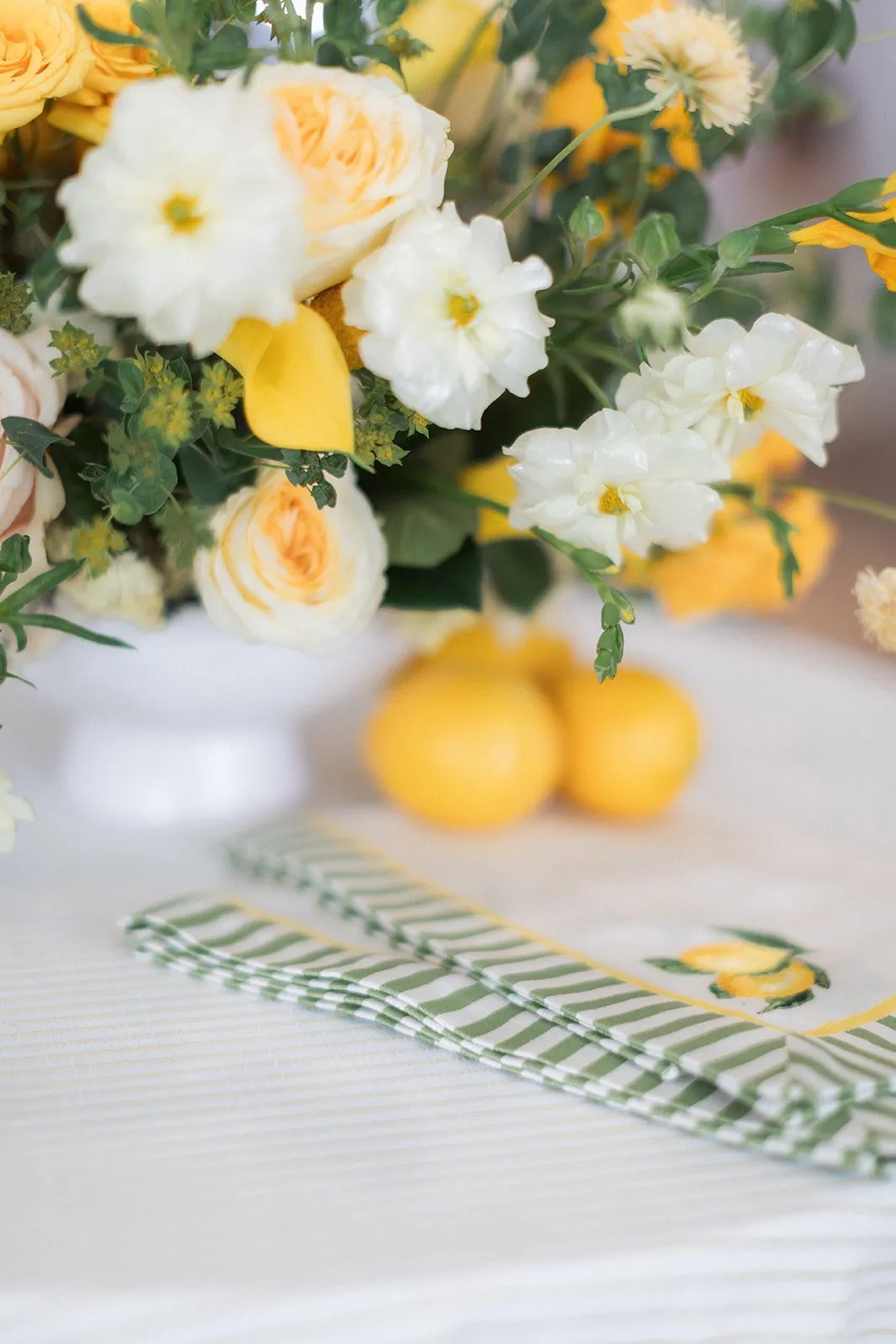 Golden roses and ranunculus with lemon accents