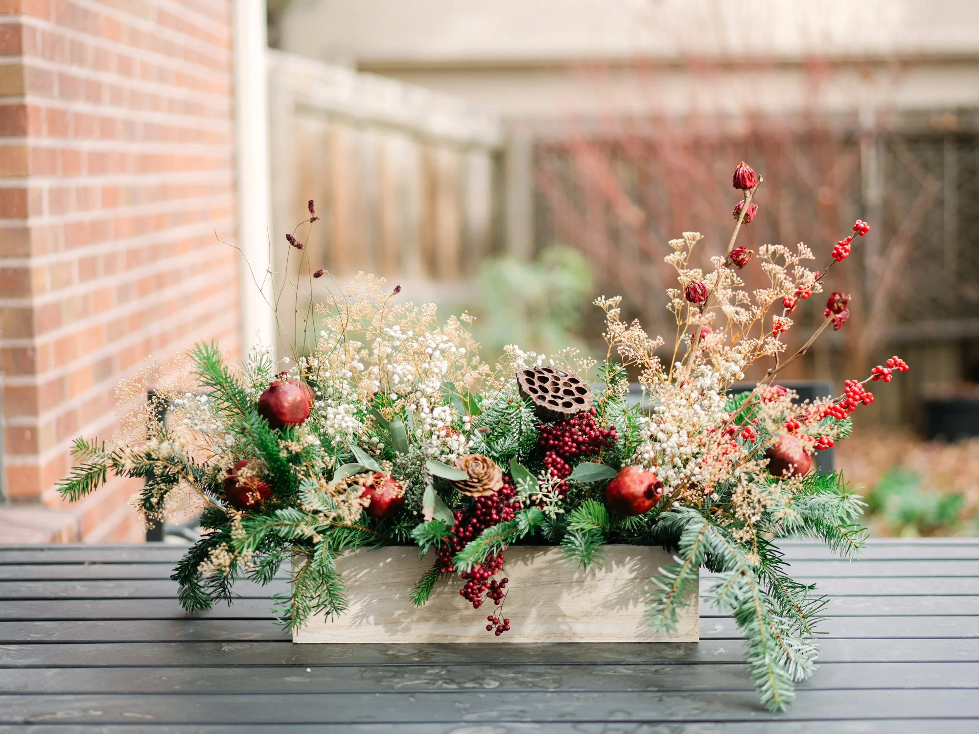 Winter blooms and greenery arrangement