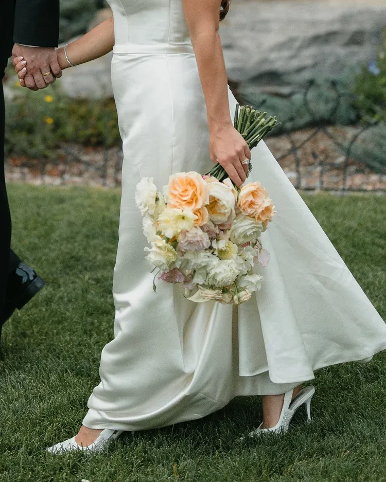 Bride holding a blush and white rose wedding bouquet