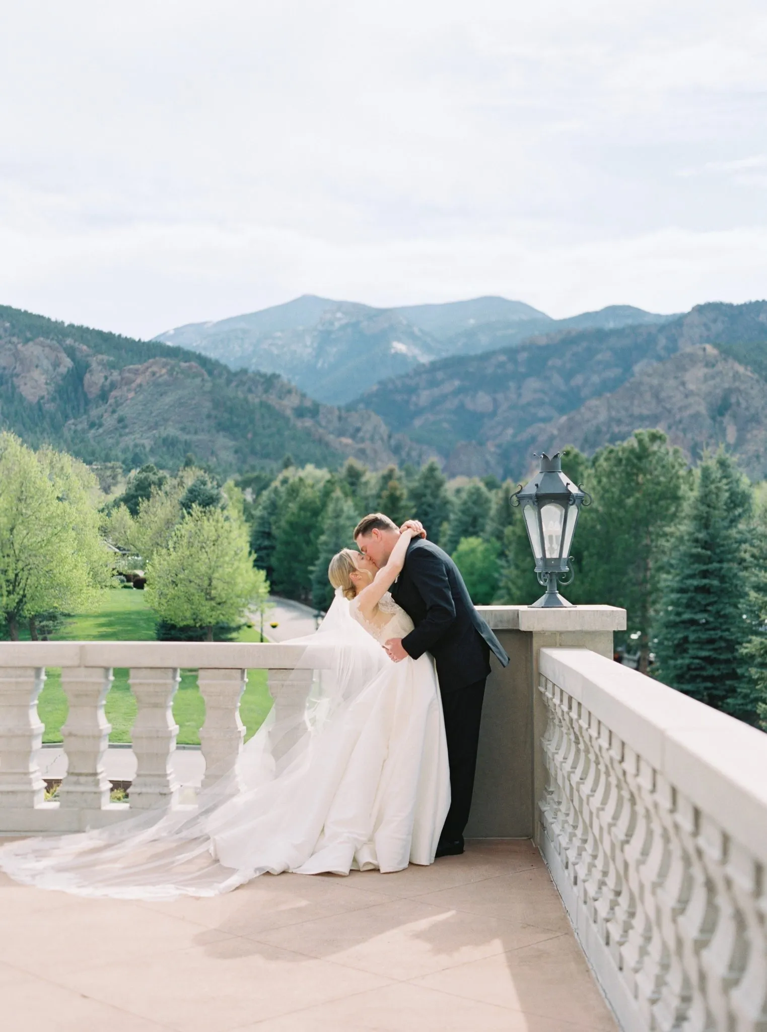 Broadmoor wedding with bride, groom, and white florals outdoors