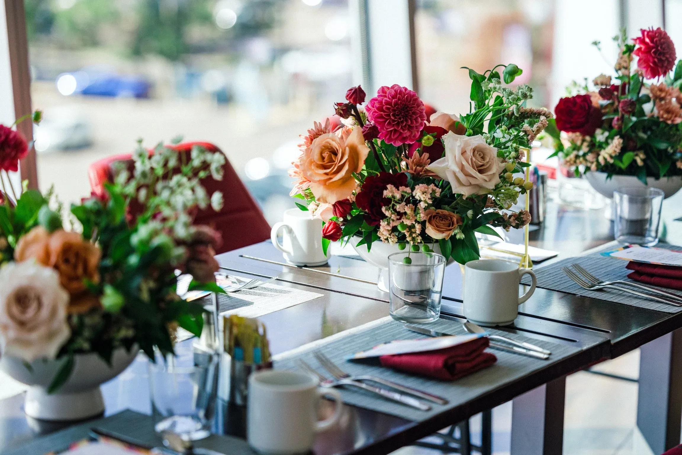 Corporate event table setting with floral centerpiece