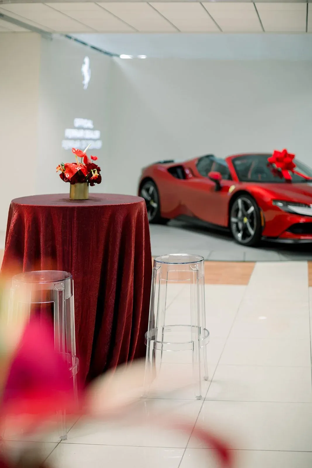 Ferrari holiday party with red floral arrangement
