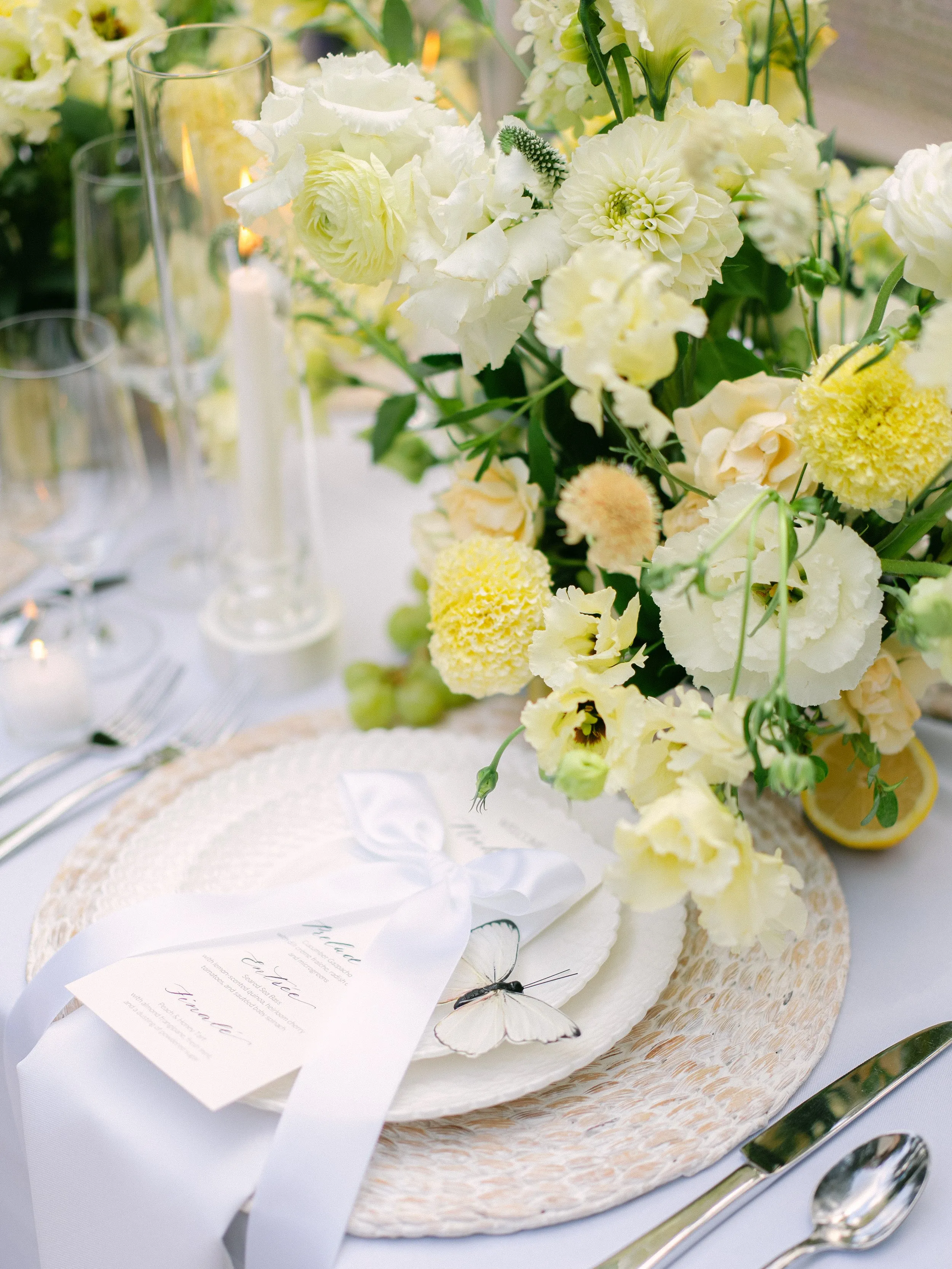 Oceana's Gardens white and yellow floral centerpiece with wedding cake