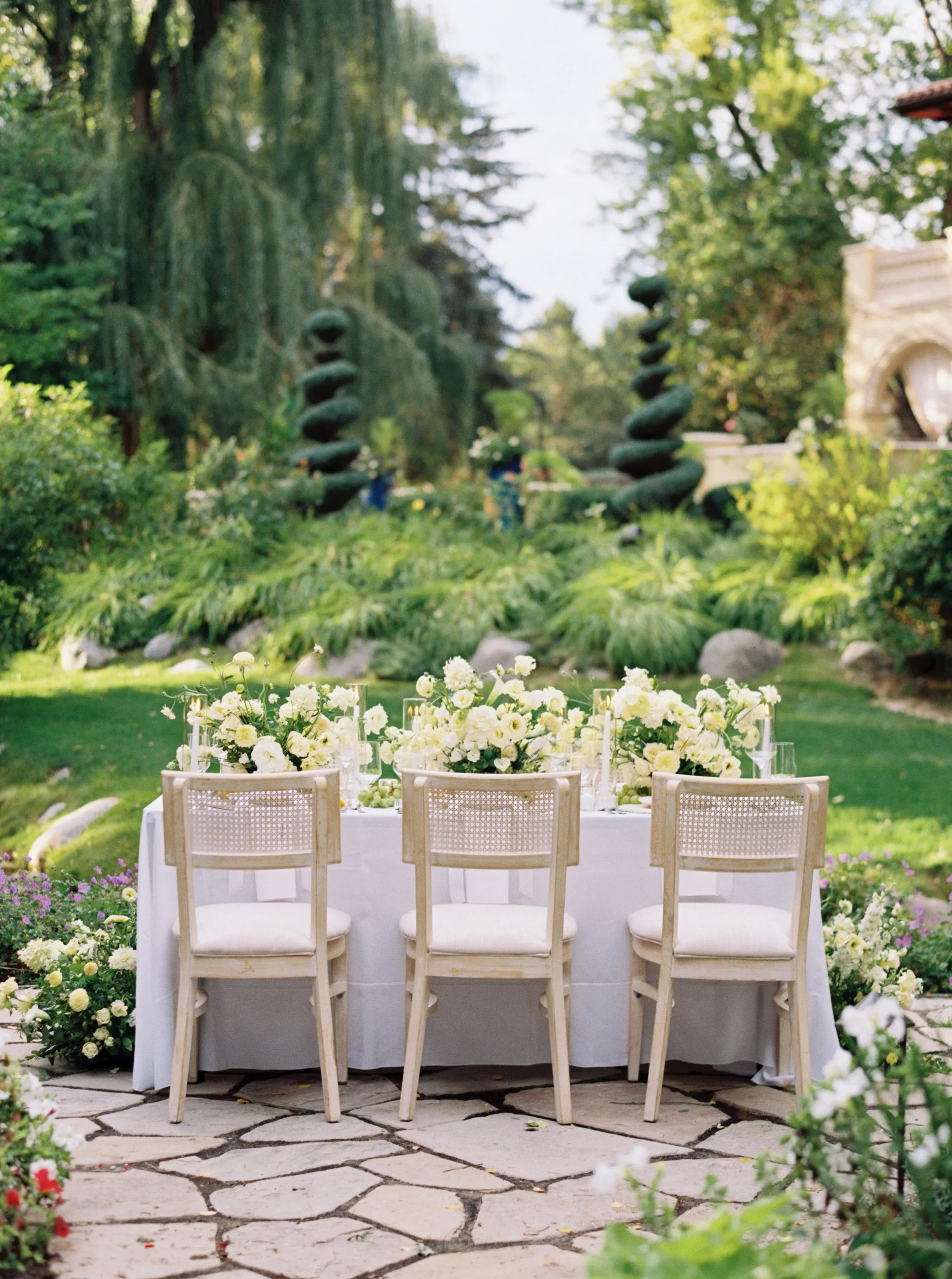 Outdoor wedding table with white flowers and candles